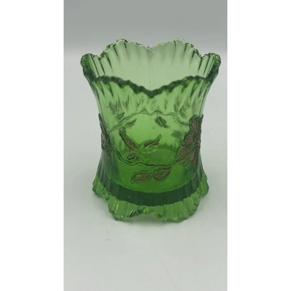 An Antique EAPG green glass spoon holder with gold floral overlay.